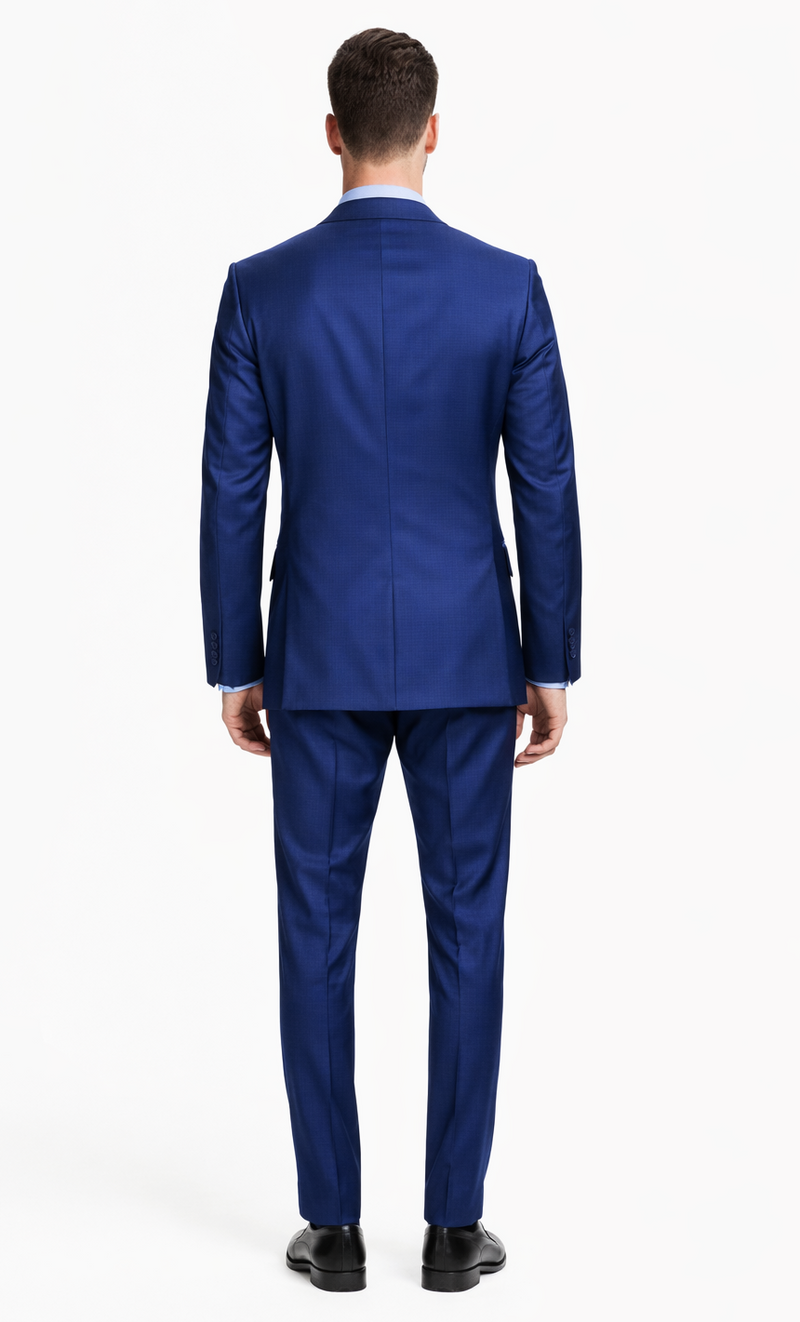 Italian-made Albertonardoni blue suit. Tailored fit, single-breasted design with a structured blazer (notch lapel, rear vent) and slim-fit trousers. Solid blue fabric, smooth texture, worn with black shoes.
