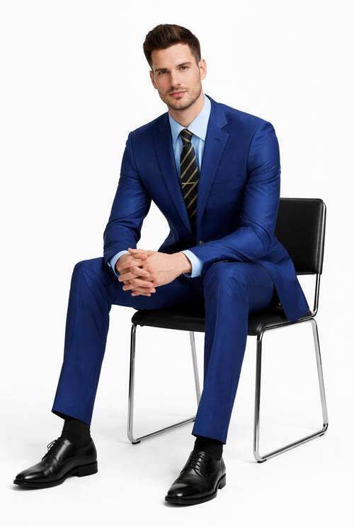 Albertonardoni's "Galante Uomo" Italian suit: tailored fit, solid blue, 2-button jacket. Smooth, subtly shiny fabric, notch lapel. Paired with light blue shirt & striped tie. Straight-leg trousers, black shoes.