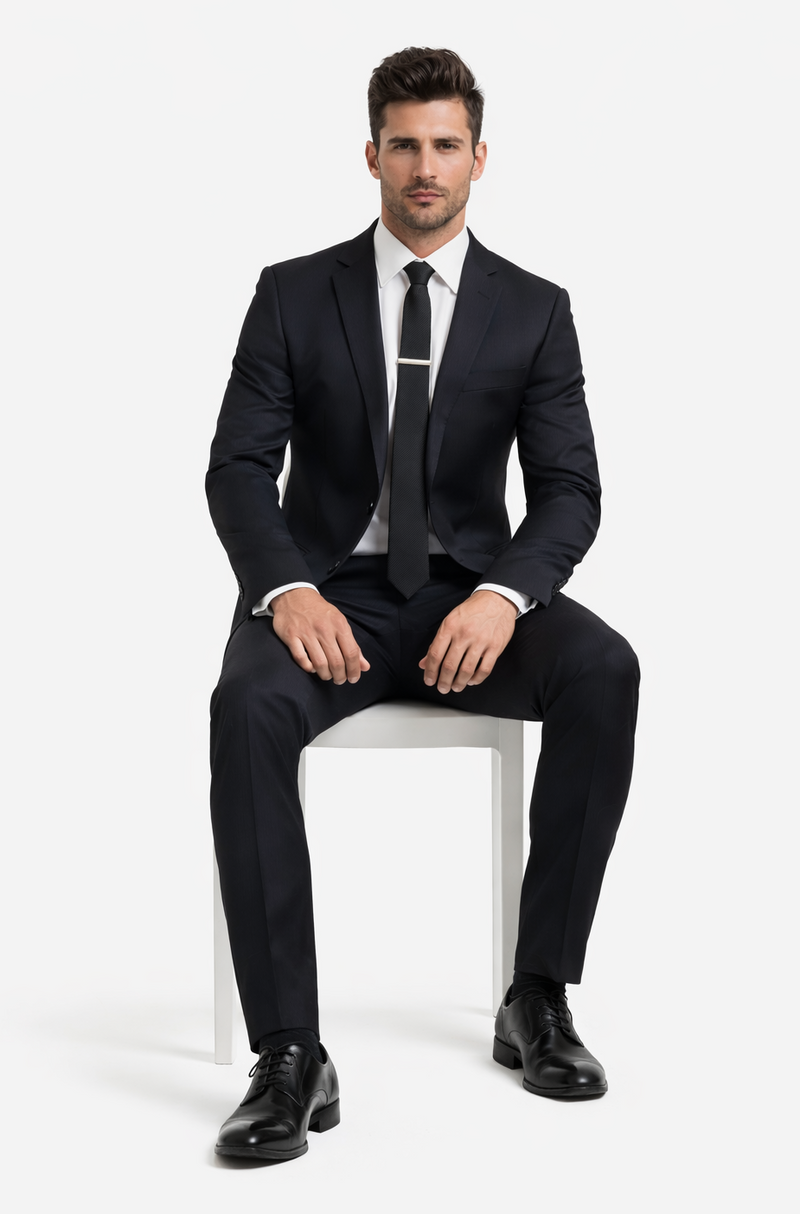 Albertonardoni black wool suit. Tailored fit, notched lapels, and button closure. Straight-leg trousers. Uniform color with a subtle sheen for a refined look.
