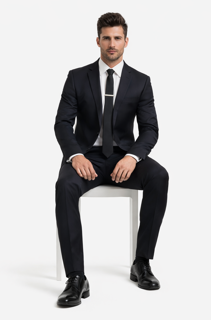 Albertonardoni black wool suit. Tailored fit, notched lapels, and button closure. Straight-leg trousers. Uniform color with a subtle sheen for a refined look.
