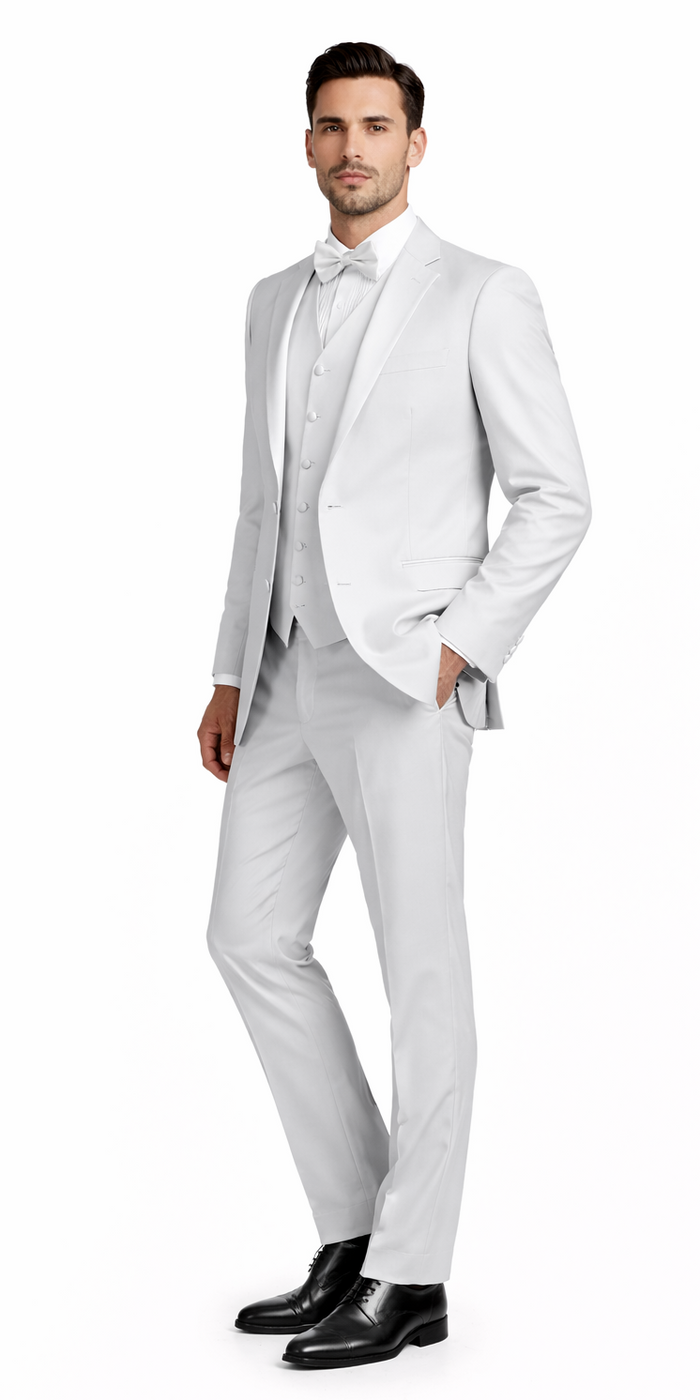 Bright white tailored suit: single-breasted jacket, notch collar, matching trousers, waistcoat, two-button closure. Smooth, subtly shiny fabric. Bow tie and black dress shoes complete the look.
