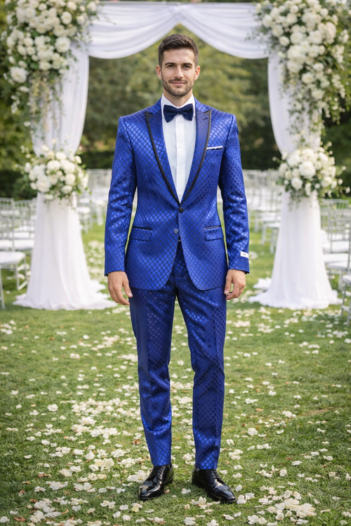Navy checkered slim fit tuxedo by Giovanni Testi. Dark blue patterned fabric with diamond check. Single-breasted jacket, notched lapel with black trim. Matching slim fit trousers. White shirt, black bow tie. Tailored, slim fit silhouette.

