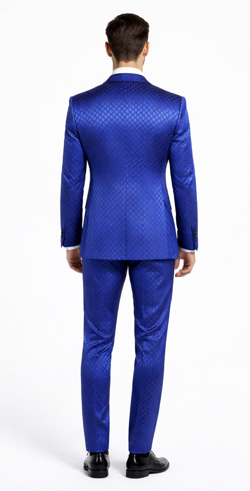 Giovanni Testi navy checkered slim fit tuxedo by Albertonardoni. Vibrant blue with a geometric pattern, structured jacket, peaked lapel, tapered waist, slim trousers. Slight sheen, likely a blend. White shirt contrast.
