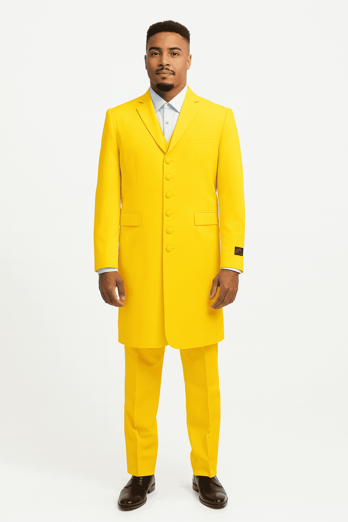 Men's zoot suit in bright yellow, smooth fabric. Features a long, tailored jacket with a notched collar, five buttons, and two pockets. Matching trousers complete the suit. 1920s vintage style, with a light blue shirt peeking through.