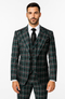 Classic fit suit. 100% wool. Green plaid with white/dark lines. Blazer w/ wide lapels. Matching vest. Baggy, pleated pants with wide-leg silhouette.