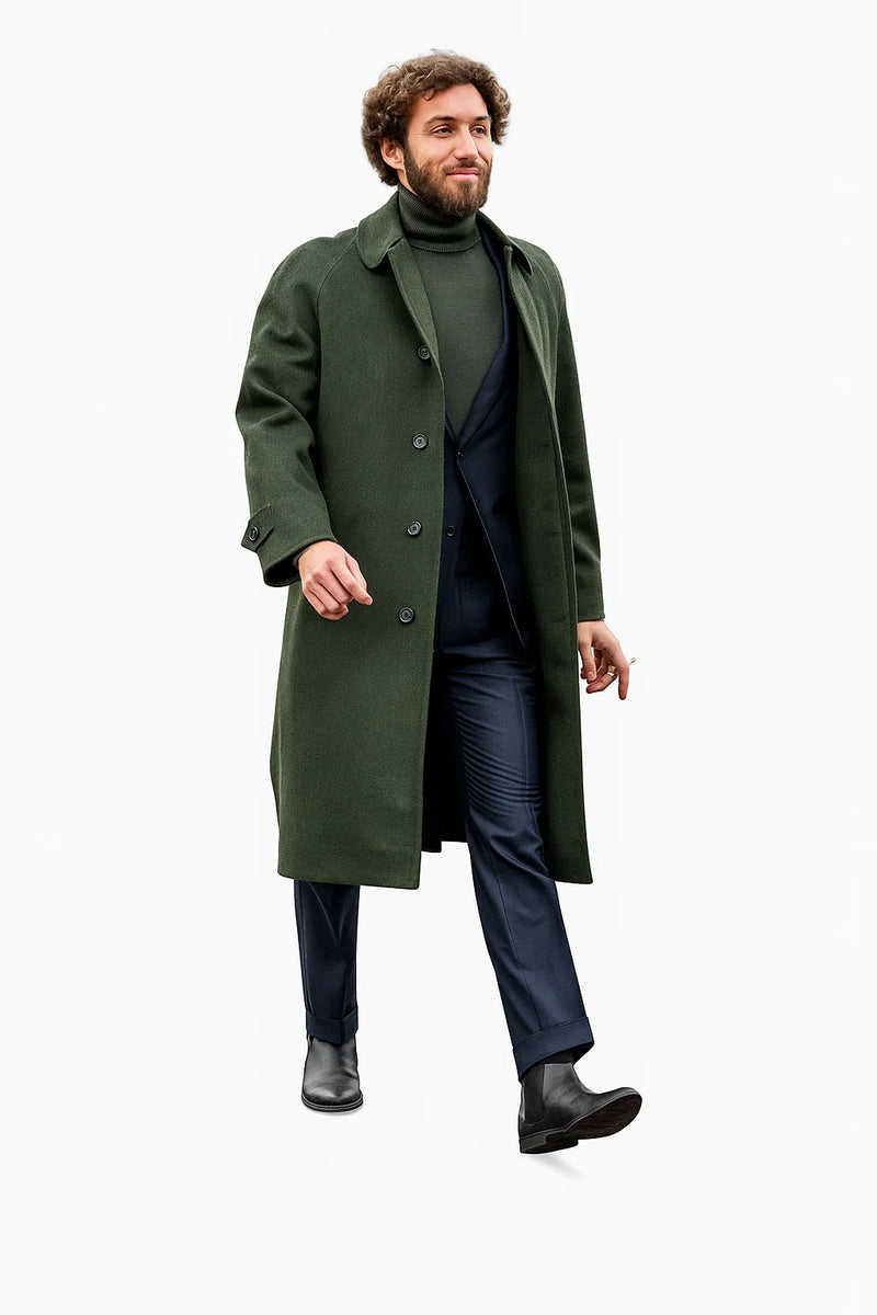 Olive green wool overcoat with shawl collar, black buttons, & straight silhouette. Paired with dark turtleneck, navy trousers. Winter business casual outfit in olive, navy, & black.
