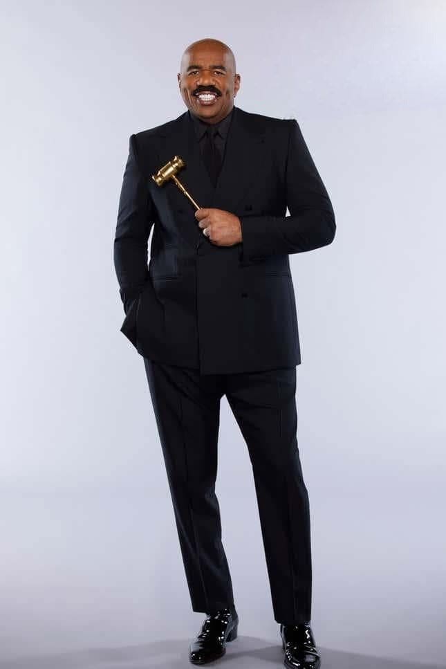 Men's Steve Harvey suit in black, double-breasted with a modern fit. Includes a tailored jacket with a structured silhouette and matching trousers with a straight leg. Polished, formal design.
