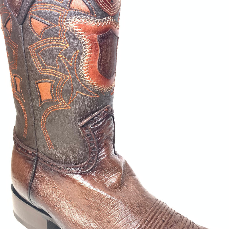 Los Altos brown ostrich quill cowboy boots. Tapered, rounded toe, raised heel. Intricate brown/orange stitching. Leather & ostrich quill for texture. Tall shaft with decorative panels and stitching.
