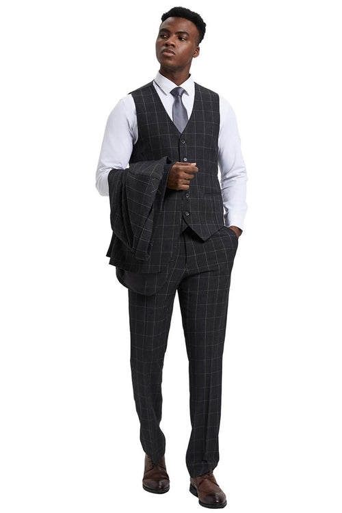 The men's Stacy Adams vest features a classic cut with a bold windowpane pattern in dark charcoal grey. It is composed of a smooth fabric and includes a front button closure.