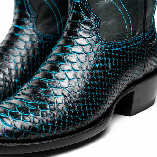 Marco Di Milano Kansas cowboy boots. Black python upper with blue stitching. Round toe, elastic side panels. Black sole. Stylish, textured design.
