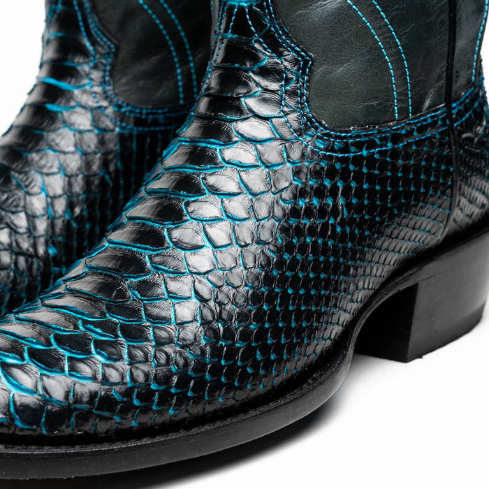 Marco Di Milano Kansas cowboy boots. Black python upper with blue stitching. Round toe, elastic side panels. Black sole. Stylish, textured design.
