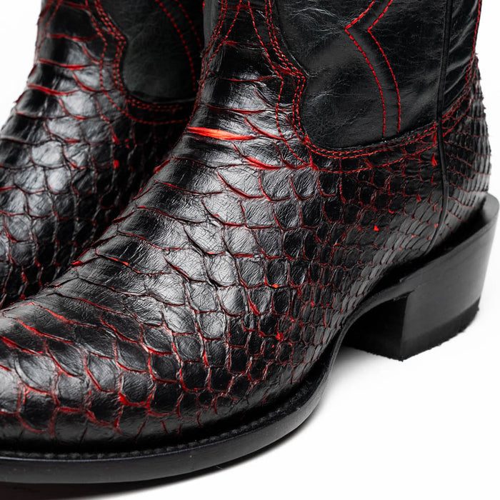 Black Marco Di Milano cowboy boots crafted from textured black python leather with scale pattern. Features red stitching and decorative elements. Classic round toe and slight heel.
