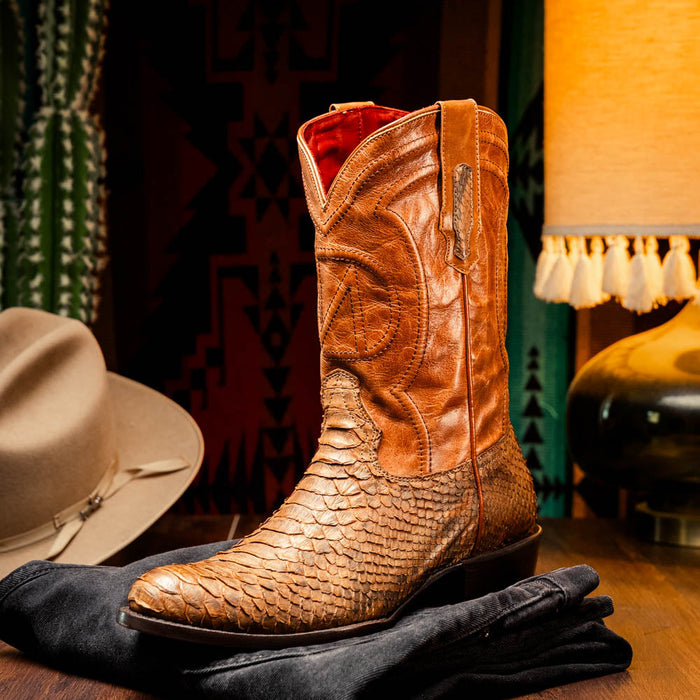 Marco Di Milano Kansas Cognac cowboy boots: round toe, tall fitted shaft. Cognac leather with textured, scaled pattern. Subtle shaft stitching & pull tab. Slender heel. Red interior lining.
