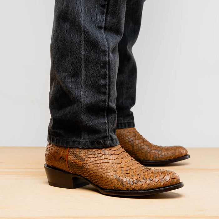 Marco Di Milano Kansas Cognac cowboy boots. Brown reptile-textured leather, rounded toe, low block heel. Smooth, streamlined profile for a classic look.
