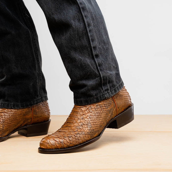 Marco Di Milano Kansas Cognac cowboy boots. Round toe, snakeskin-textured leather upper in a rich cognac hue. Streamlined silhouette, low stacked heel.
