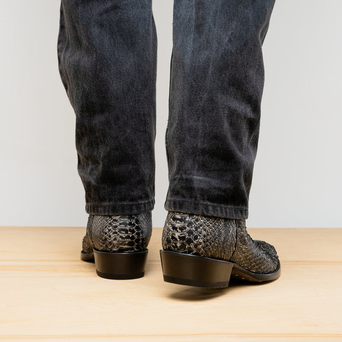 Marco Di Milano Kansas Stone boots: Round toe, textured snakeskin-like surface in white/gray tones. Black heel. Classic cowboy boot silhouette.
