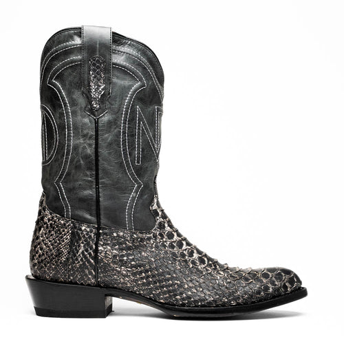 Black leather cowboy boots with round toe. White stitching and embossed details adorn the upper. Lower section features dark snakeskin texture. Slightly curved stacked heel.
