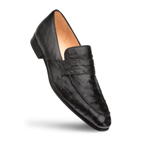 Black Mezlan Lisbon penny loafers in ostrich quill leather. Pointed toe, low heel. Textured upper with dimples. Classic design with a vamp strap. Tan interior lining.

