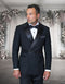 The Statement mens 2 piece tuxedo features a modern fit, double breasted design with a black color scheme. Made from 100% wool, it has satin lapels and a textured belt detail. The tuxedo includes a white shirt and a bow tie, presenting a formal appearance.