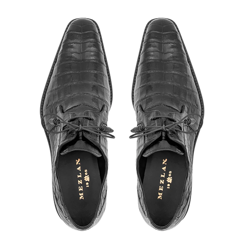 Black Mezlan Anderson derby shoes with crocodile texture. Pointed toe, leather, lace-up. Black insole with gold branding. Flat black outsole. Slender profile.
