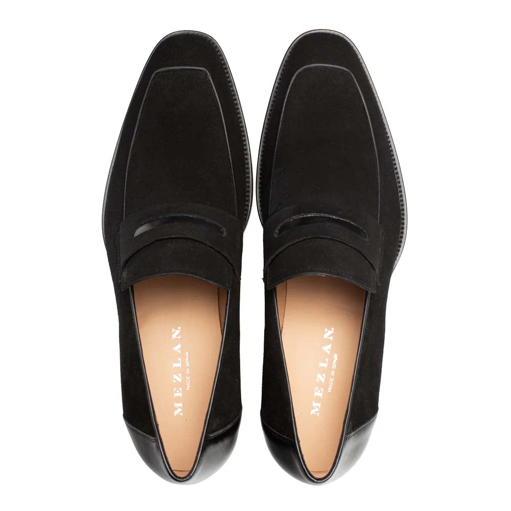 Black Mezlan Galeno suede penny loafer. Rounded shape, flat front with penny strap. Black suede upper, smooth leather lining, and a contrasting black leather heel.
