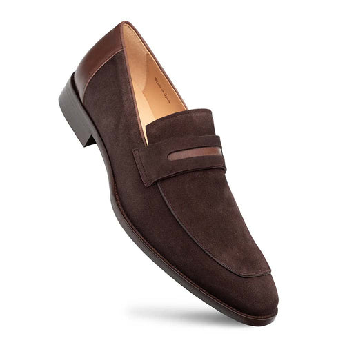 Mezlan Galeno suede penny loafer in brown. Streamlined shape with rounded toe, leather accents, and penny keeper strap. Flat sole. Sleek, tapered design.
