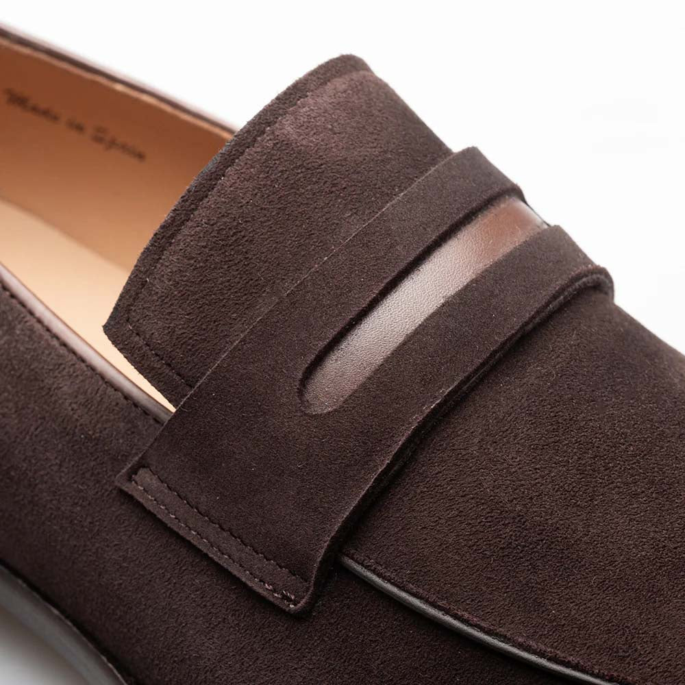 Mezlan Galeno brown suede penny loafers with rounded toe & flat heel. Soft suede upper, leather accent band, visible stitching, and a light-colored interior lining.
