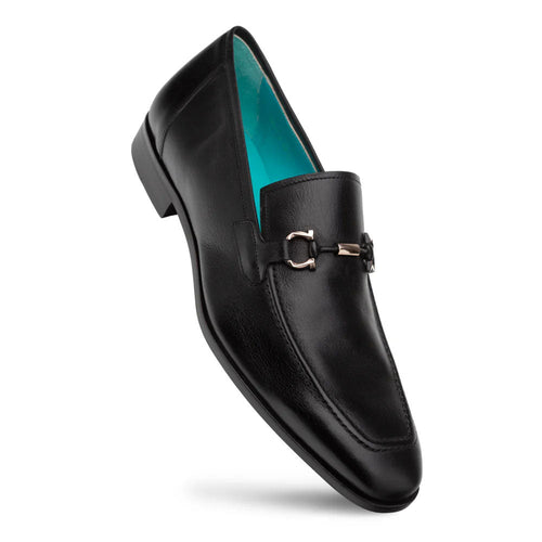 Black leather Mezlan Rios loafer with elongated shape. Features a metal ornament and light blue interior. Flat sole with heel elevation for a refined look.
