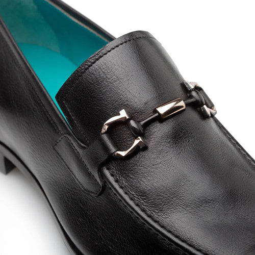 Black leather Mezlan Rios loafer. Rounded toe, decorative ornament, light blue lining. Flat sole with slight heel elevation.
