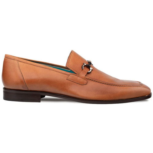 Cognac Mezlan Rios Flex loafer with elongated shape and pointed toe. Smooth leather, metal ornament, stitched detail. Dark brown sole. Blue interior lining. Formal style.

