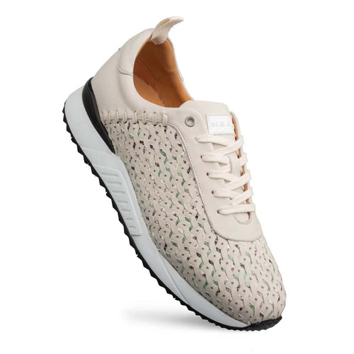 Mezlan Plata Laser Cut Sneaker: Light green, multi-toned upper with laser-cut pattern and beige accents. Rounded toe, black sole, thick white midsole. White flat laces.
