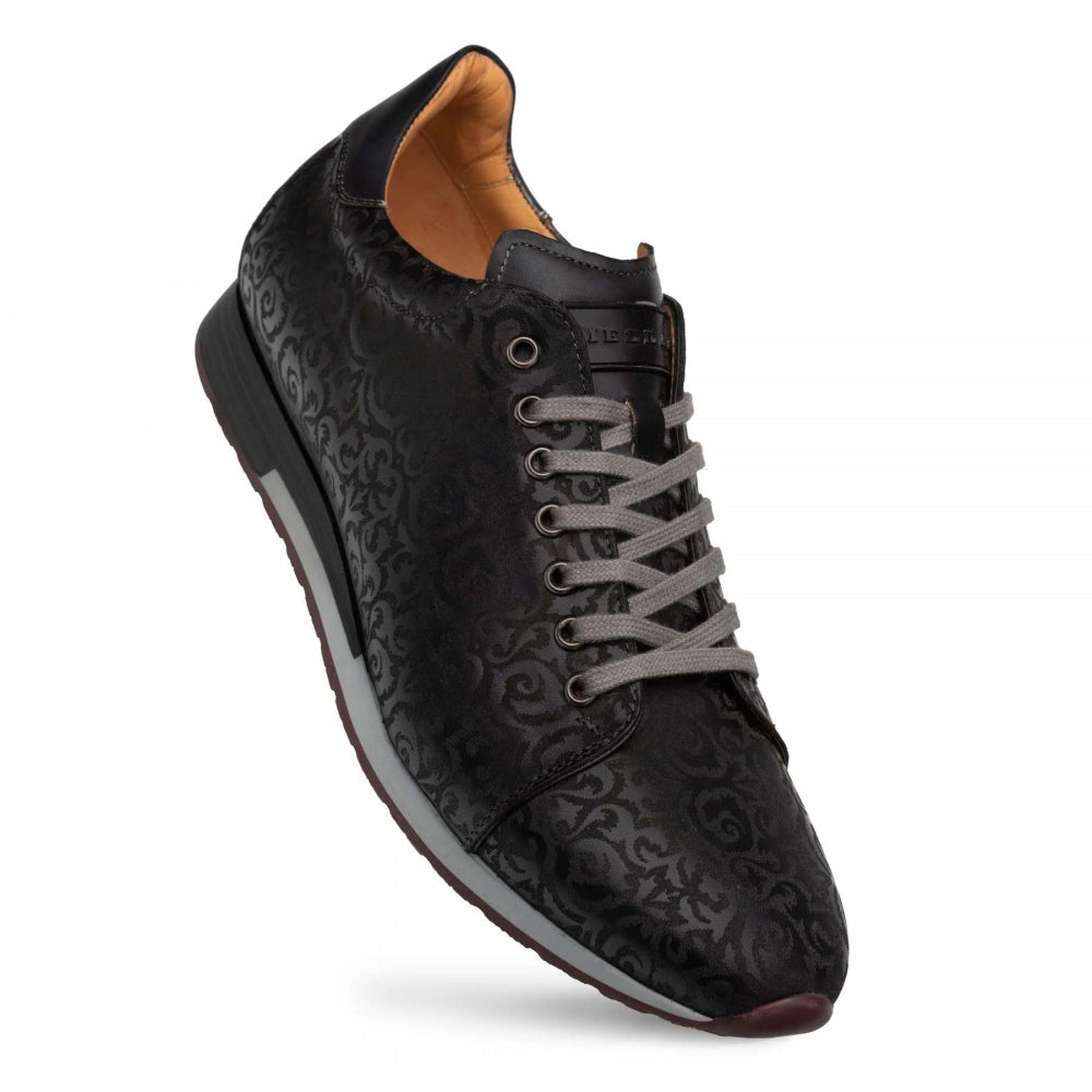 Mezlan Portico sneaker in black: leather upper with laser-printed pattern. Rounded toe, low profile, grey laces. Dark rubber outsole, tan lining.
