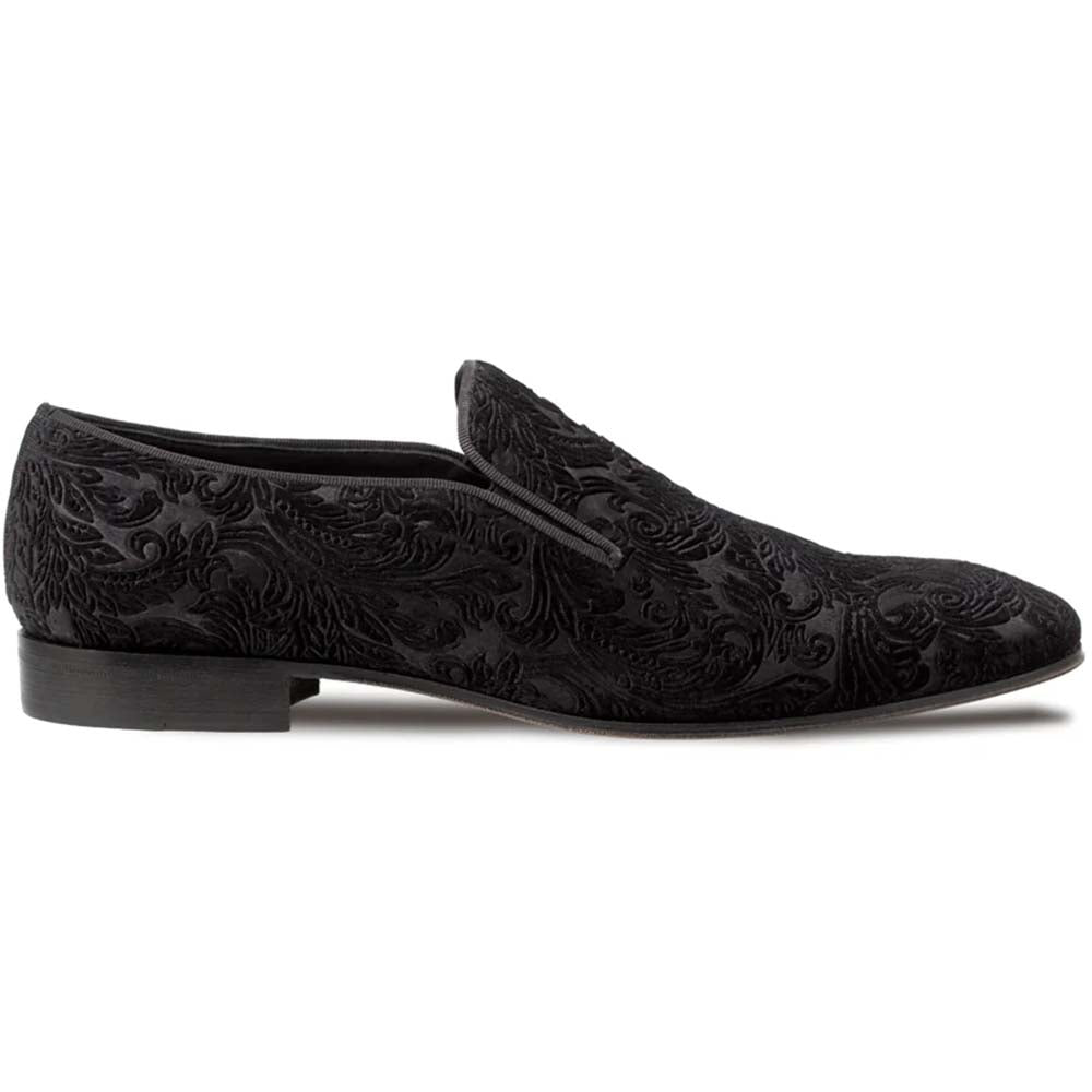 Mezlan Travolta loafer. Black velvet upper with raised pattern. Elongated shape, low heel, and slip-on design. Leather sole for support. Formal and stylish.
