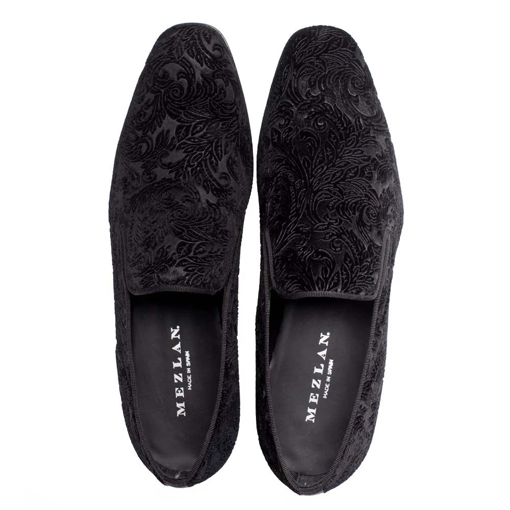 Mezlan Travolta loafer: Black velvet with tonal floral pattern. Slim, elongated silhouette, slightly elevated heel. Slip-on design, padded collar, black fabric lining, and rubber sole.
