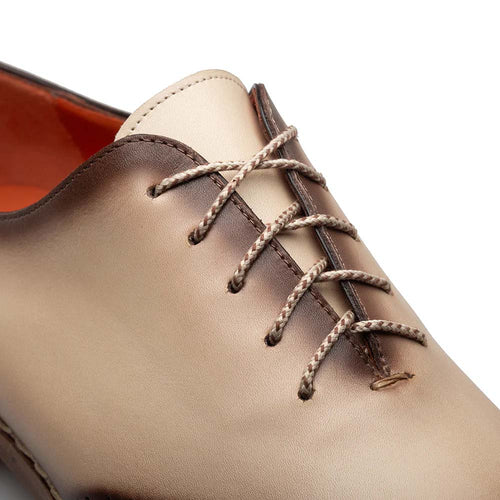 Mezlan Almagro two-tone oxford. Smooth leather upper with red-to-bone gradient. Rounded toe, intricate lace eyelets, textured laces. Visible stitching, orange inner lining.
