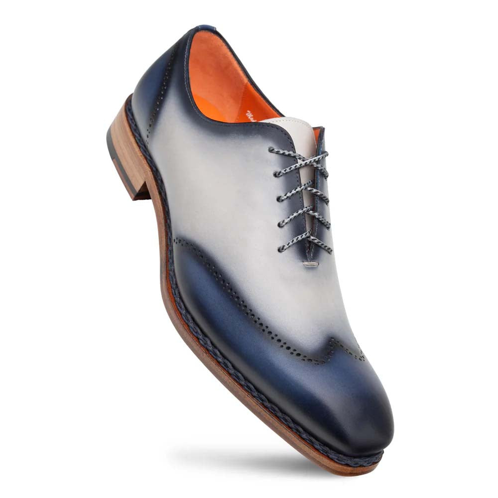 Mezlan Almagro oxford: two-tone navy-grey leather with a gradient effect. Pointed toe, broguing, and grey laces. Wooden sole for contrast. Structured form, smooth finish.
