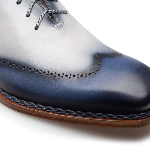 Mezlan Almagro Oxford: Two-tone navy-to-pearl grey leather. Rounded toe, decorative perforations. Braided welt, light brown sole. Dark grey laces.
