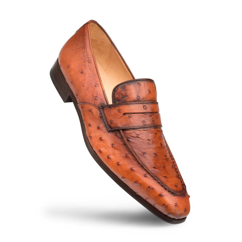 Mezlan Lisbon penny loafers in textured ostrich leather. Pointed toe, low-profile design, brandy color with quill dots. Penny strap detail. Slightly raised heel.
