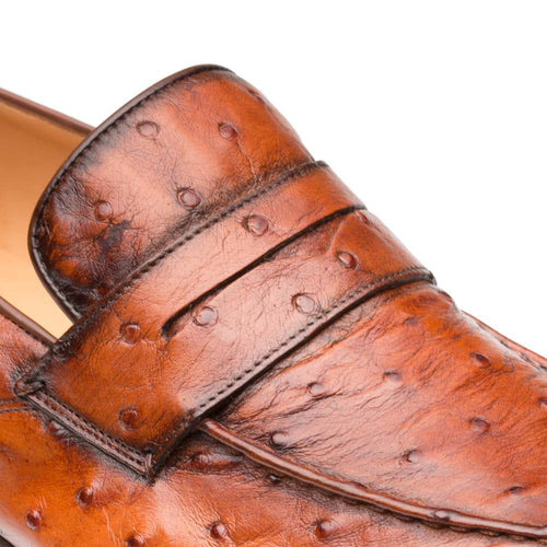Mezlan Lisbon penny loafers in brandy ostrich quill. Rounded toe, decorative strap, and textured, bumpy leather surface. Sleek shape with contrasting lining.
