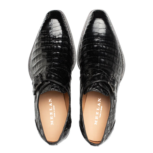 Mezlan Gigolo Monk Strap: Black crocodile leather upper with pointed toe and single buckle. Tan leather lining. Elegant, curved outsole. Glossy, textured finish.
