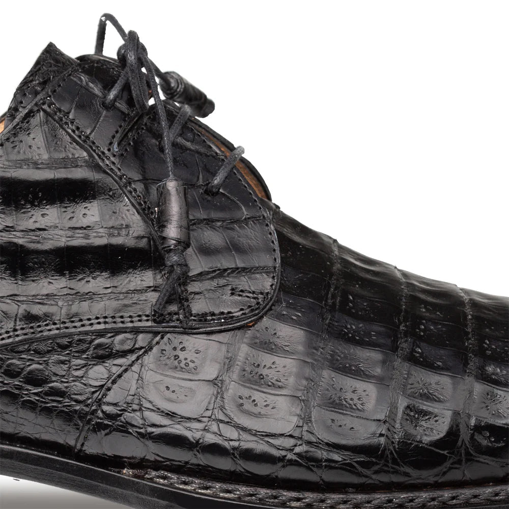 Mezlan Cratos Derby: Black crocodile leather upper with rounded toe and flap lacing. Textured, glossy finish showcasing visible scales. A luxurious and structured design.
