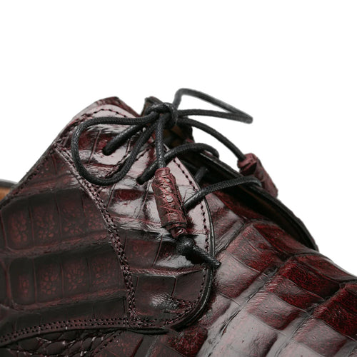 Burgundy Mezlan Cratos derby with crocodile texture. Rounded toe, shiny scales, and black laces with a toggle closure. Features a smooth inner lining for seamless design and material integration.
