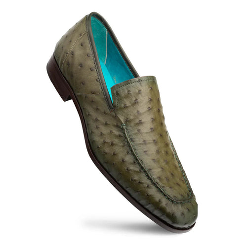 Olive Mezlan Menor slip-on: sleek, elongated shape. Textured ostrich leather upper with small bumps. Turquoise lining, brown leather sole, and stitched edges.

