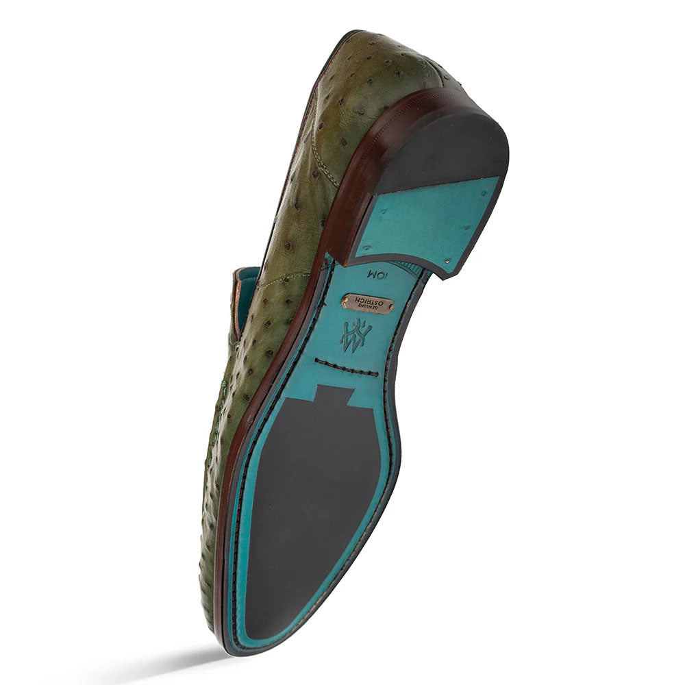 Olive Mezlan Menor ostrich slip-on with rounded toe. Features: olive upper, turquoise lining/insole, black rubber sole with wooden heel. Visible stitching for durability.
