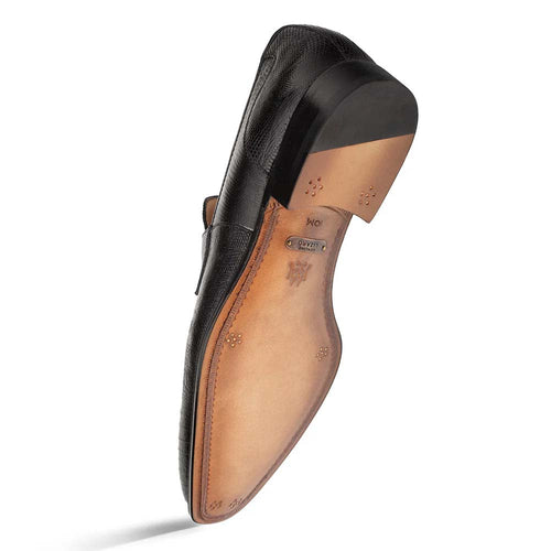 Black Mezlan Mayor penny loafer with textured leather. Elongated silhouette, classic penny slot. Tan leather sole, visible stitching, slight heel. Formal black design, contrasting tan sole.
