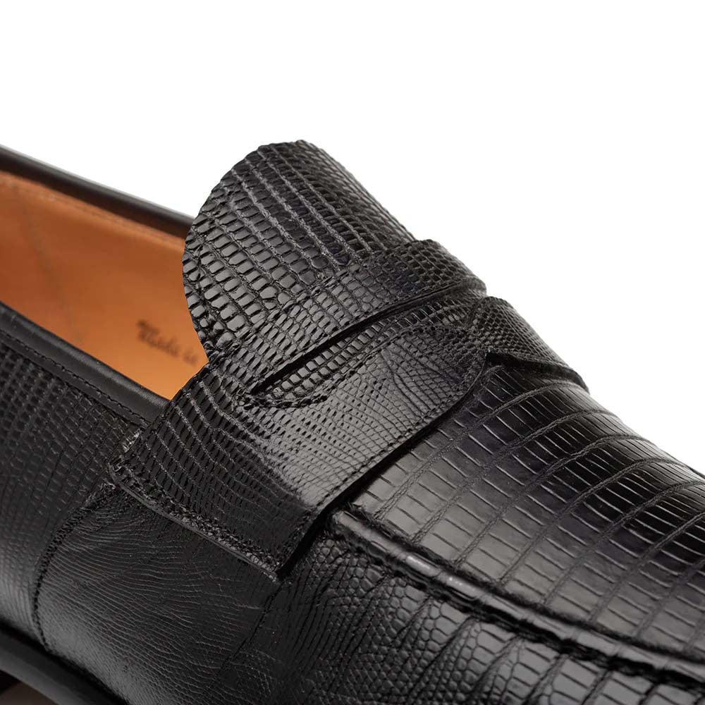 Black Mezlan Mayor lizard penny loafer. Smooth, rounded toe and flat, slip-on design. Black lizard skin upper with textured pattern. Features penny keeper strap. Leather lining.

