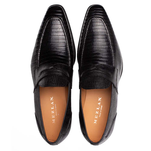 Mezlan Mayor Lizard Penny Loafer in black. Sleek, elongated shape with embossed lizard skin. Penny slot detail, rounded toe. Tan interior lining with brand marking. Deep, uniform black color.
