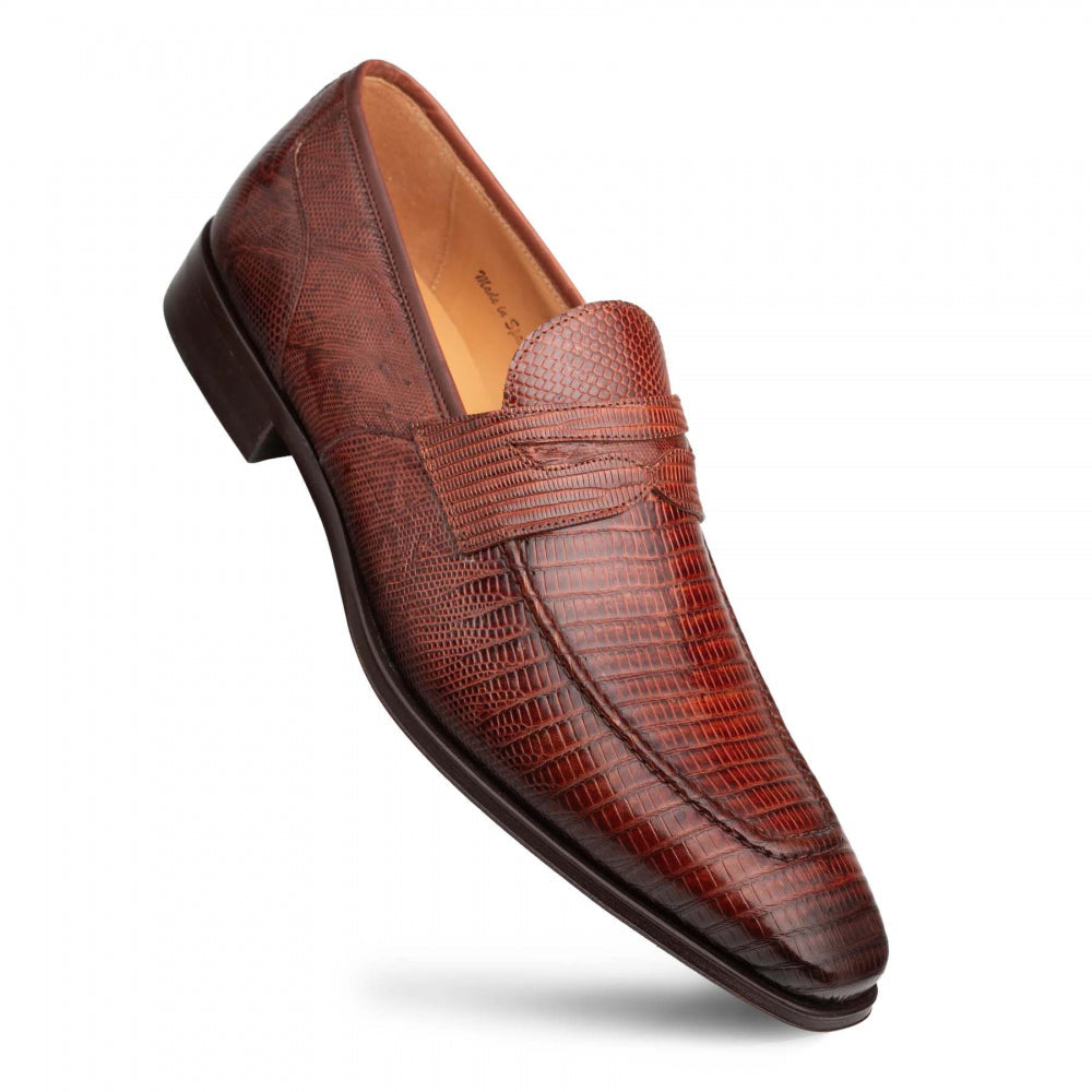 Mezlan Mayor Lizard Penny Loafer in cognac. Tapered, low-cut silhouette crafted from lizard-embossed leather. Features penny strap and textured pattern. Dark outsole provides contrast.
