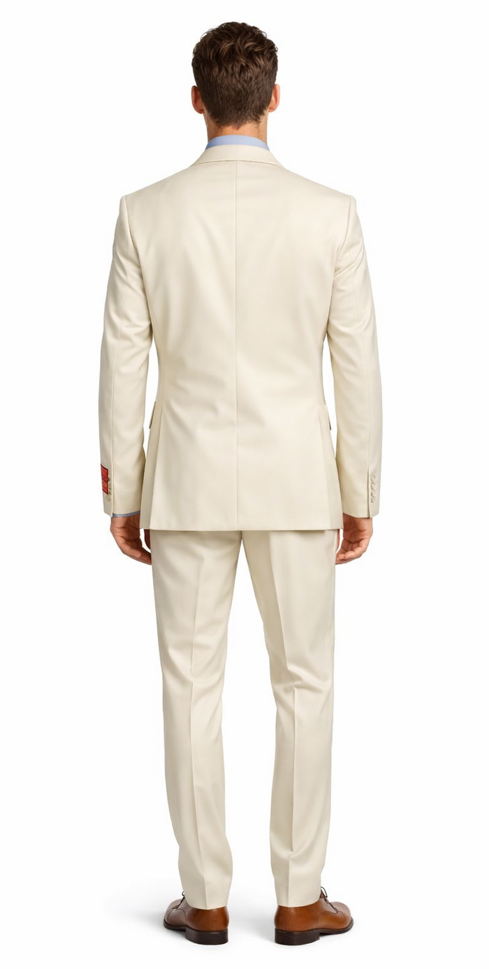 Mantoni beige wool suit: tailored fit, structured silhouette. Two-button jacket, single vent. Flat-front, tapered trousers. Solid beige. Paired with brown shoes.
