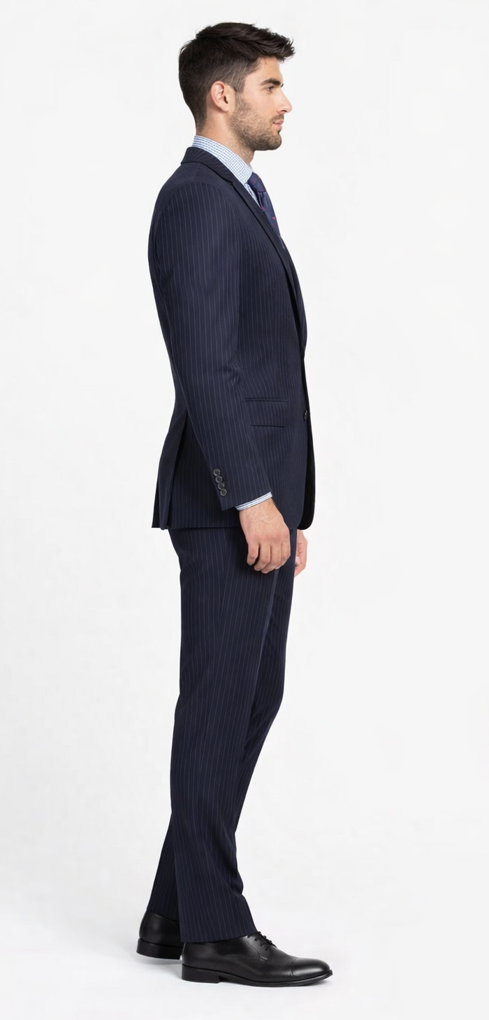 Mantoni navy wool suit with black/gray stripes. Two-button, single-breasted jacket, straight-leg trousers. Form-fitting silhouette. Paired with black dress shoes.

